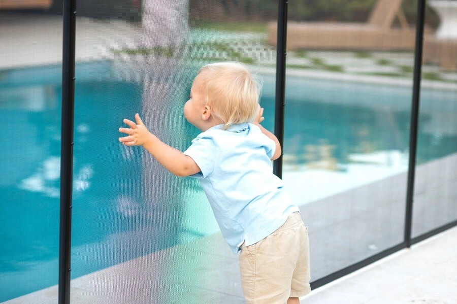 Kid holding the removable pool fence west palm beach