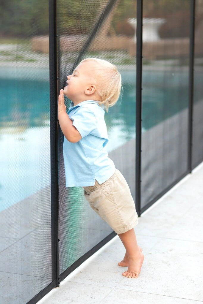 child on a pool safety fence west palm beach