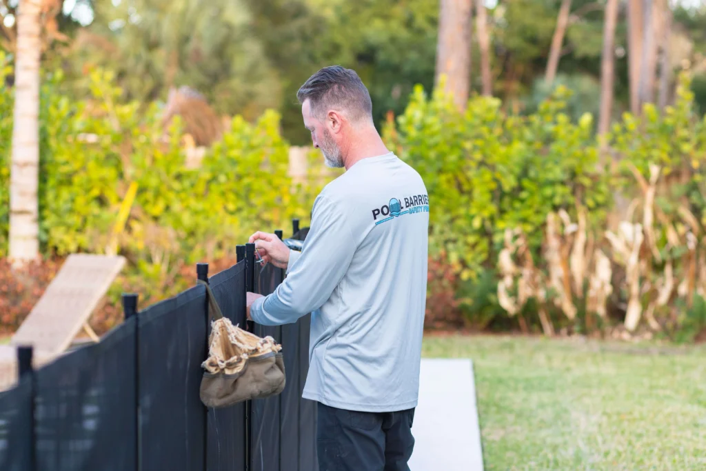 Man installing removable pool fence palm beach county (1)