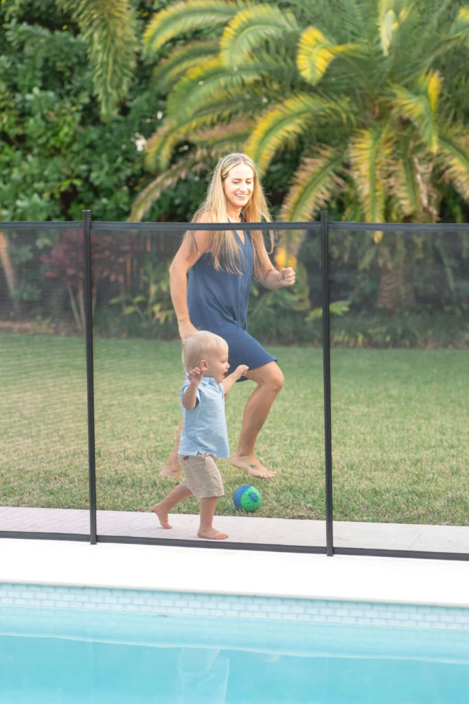 Mother and child running with removable pool fence palm beach county (1)