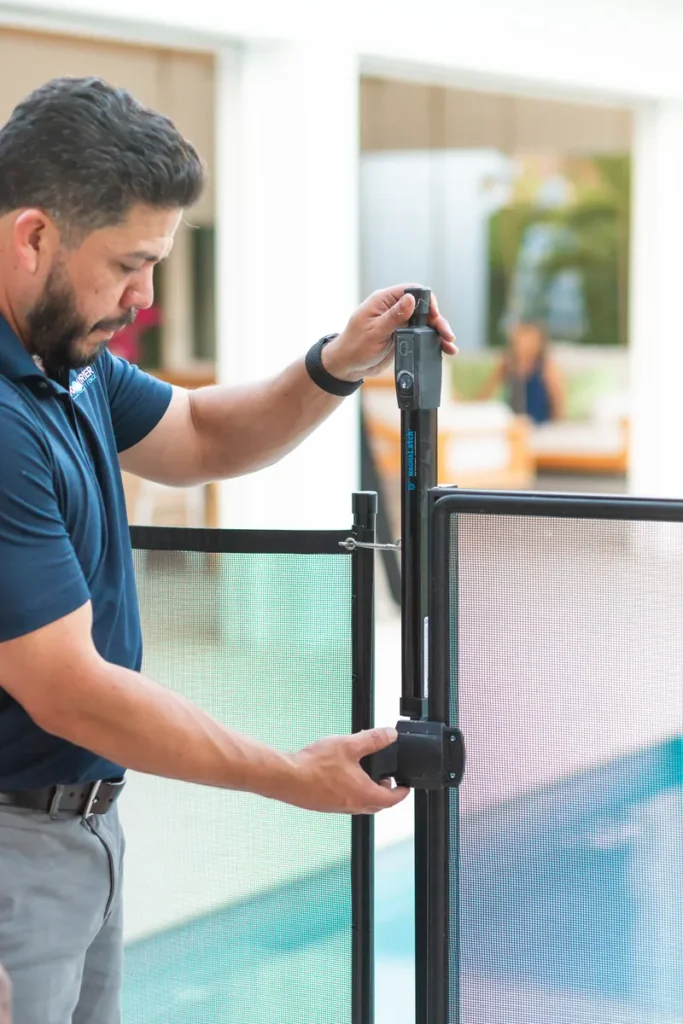 Man fixing the pool fence palm beach gardens